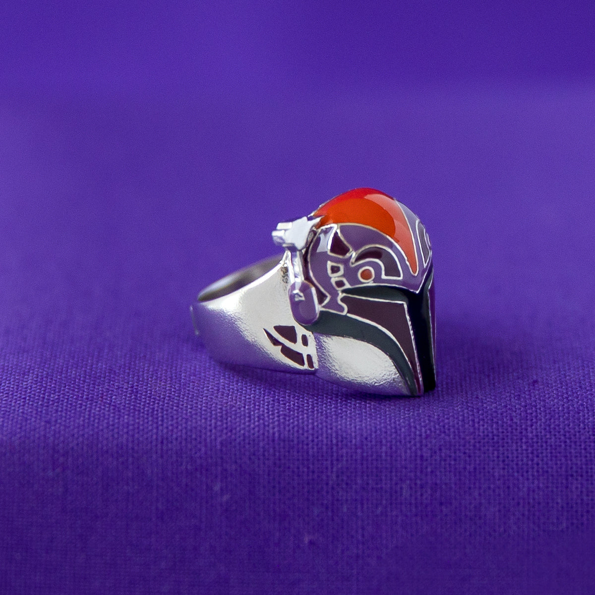 Close-up of the antiqued sterling silver finish and the intricate enamel painting on the Sabine Wren ring.