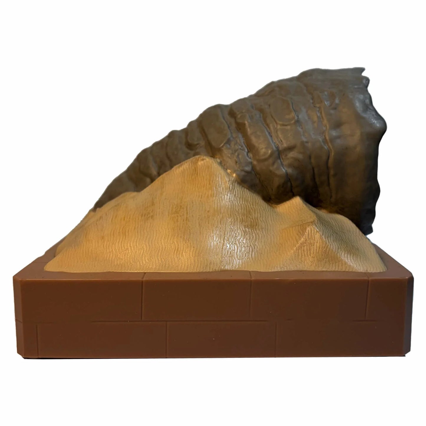Lifestyle shot of the Dune Shai-Hulud speaker displayed on a modern bookshelf