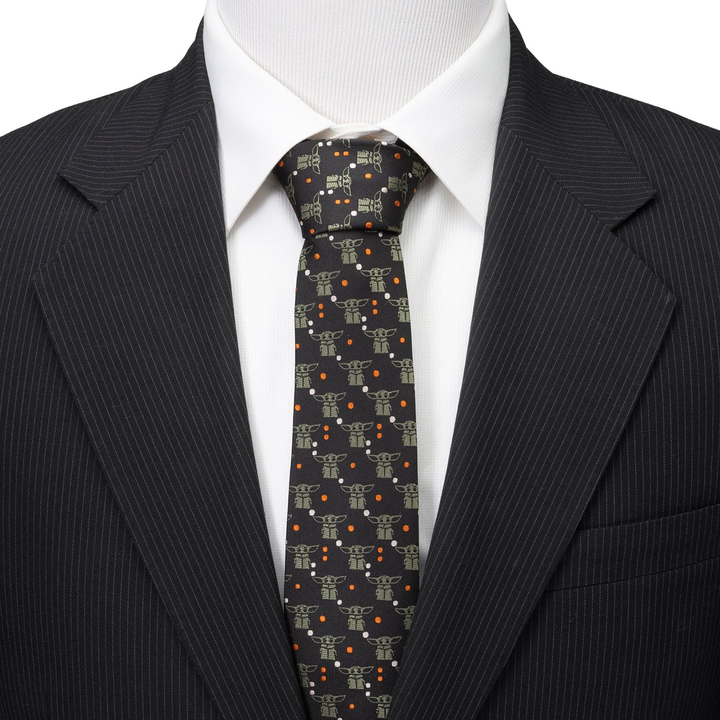 Close up of sage green Grogu motif on black tie