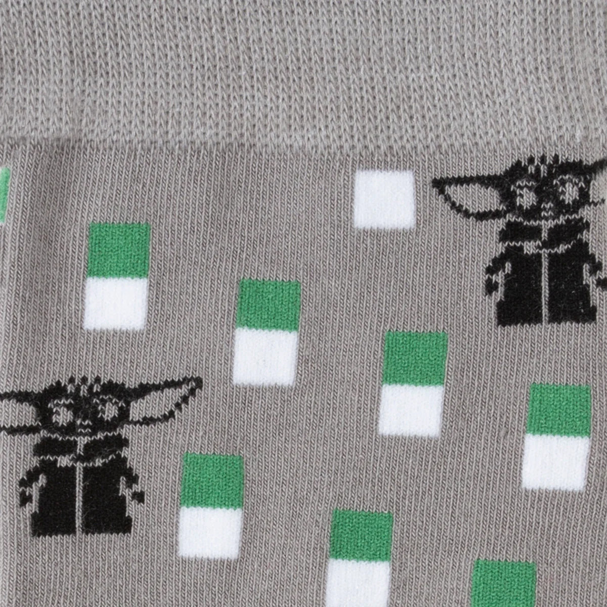 Detailed view of the Grogu lapel pin included in the gift set.