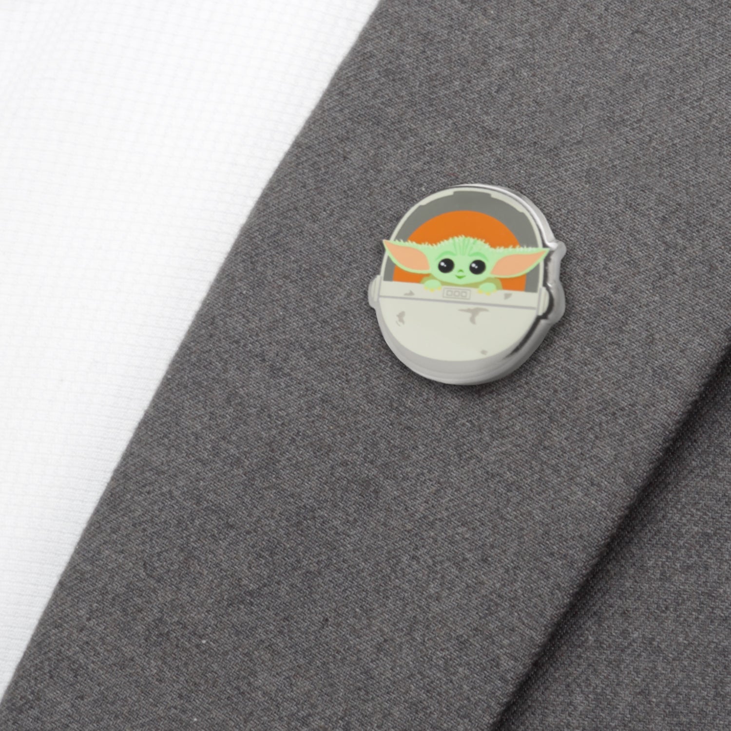 Grogu pin on a backing card with Star Wars branding