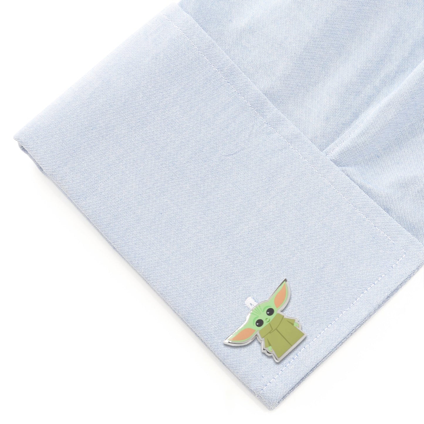 The pair of Grogu cufflinks displaying two different character poses.