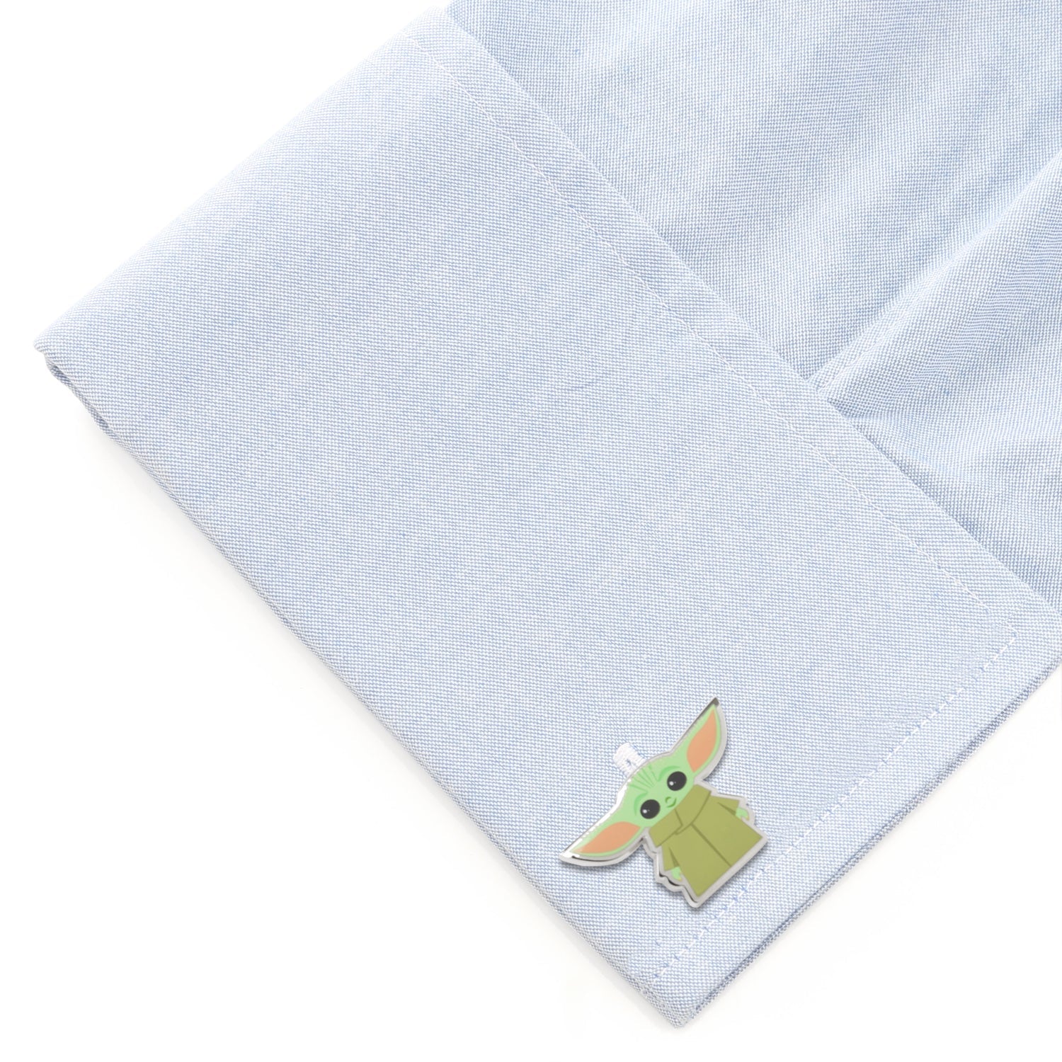 The pair of Grogu cufflinks displaying two different character poses.