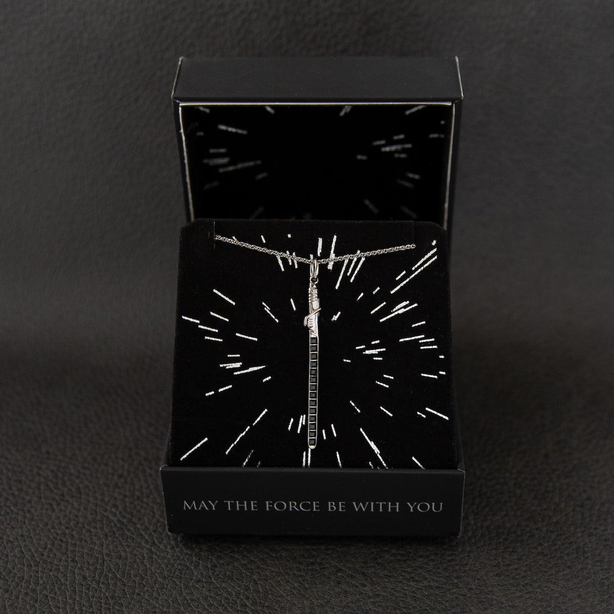 Side profile of the Darksaber pendant illustrating the sleek, handcrafted sterling silver construction.