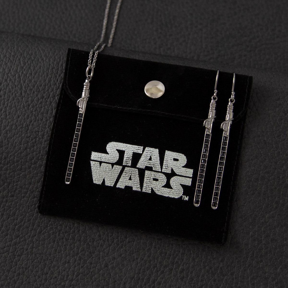 Detailed view of the square-cut crystals embedded in the Darksaber blade earring.