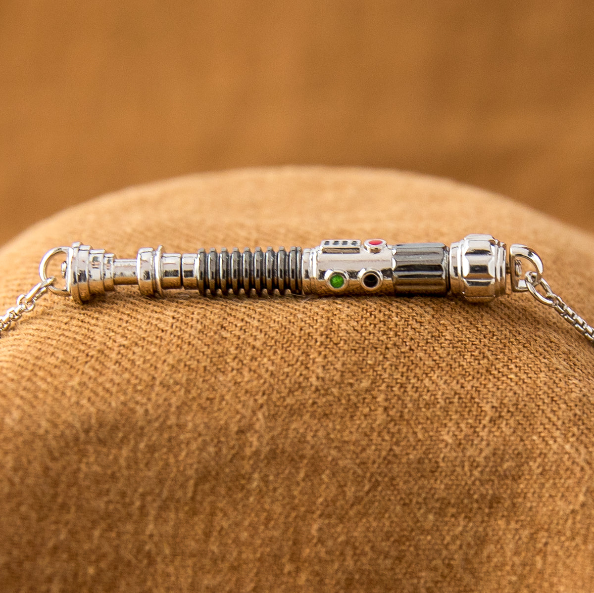 Profile view of the Duty and Resolve pendant showing enamel detailing and artisan brass construction.