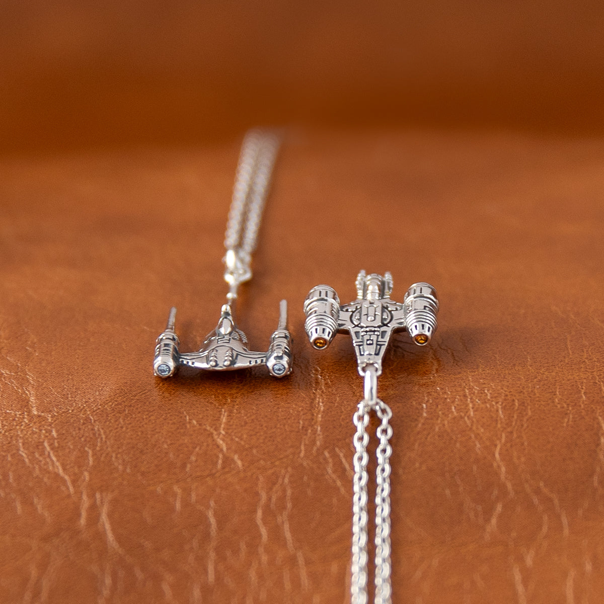 Close up of the engine thrusters with amber CZ stones on Razor Crest necklace