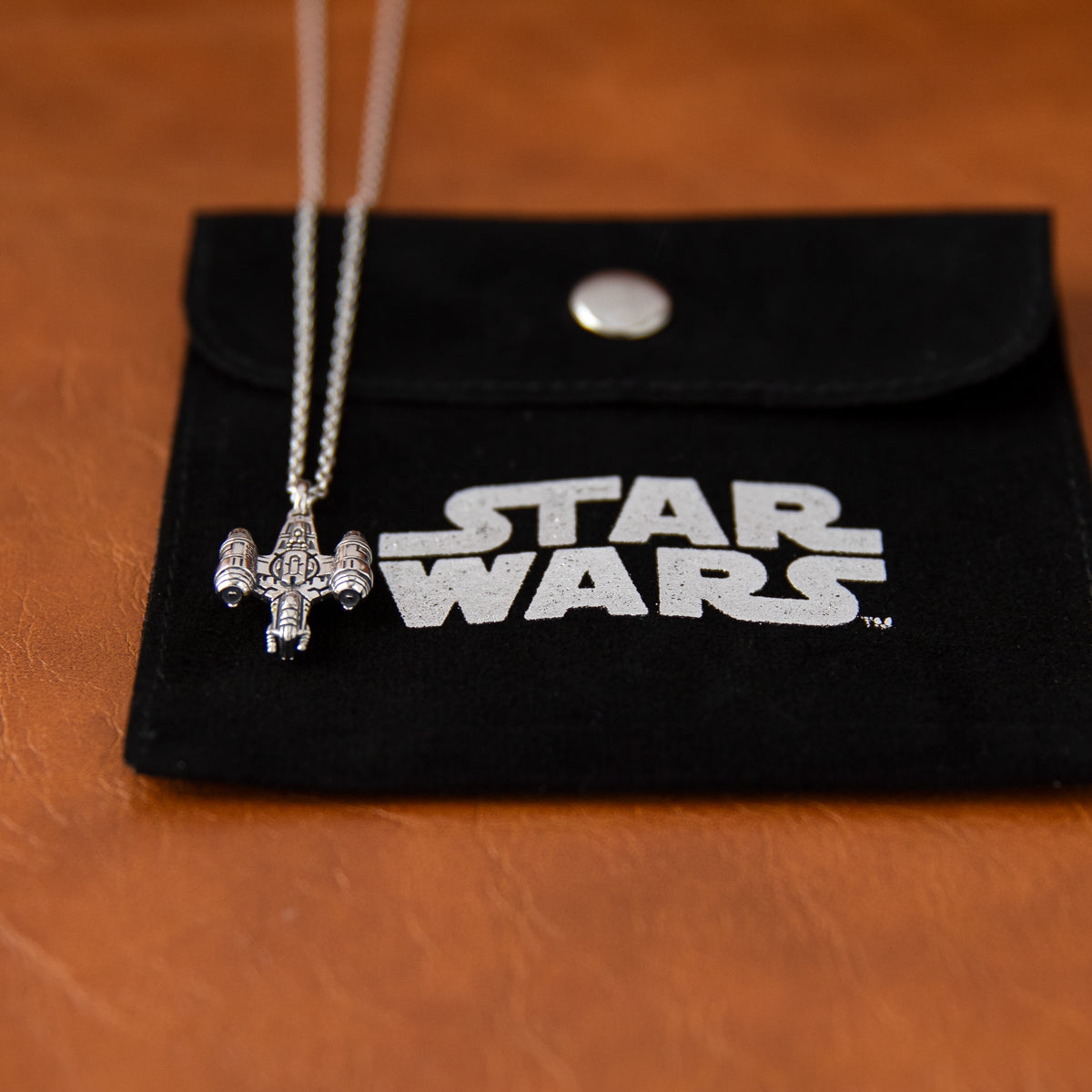 Top down view of the Razor Crest sterling silver necklace