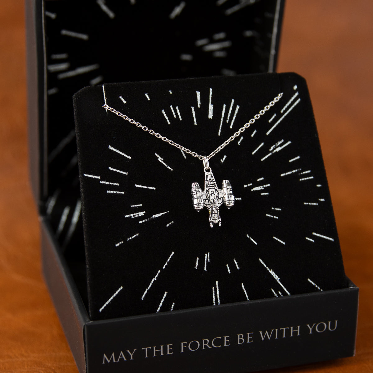 Full view of the Star Wars x RockLove Razor Crest Necklace on plain background