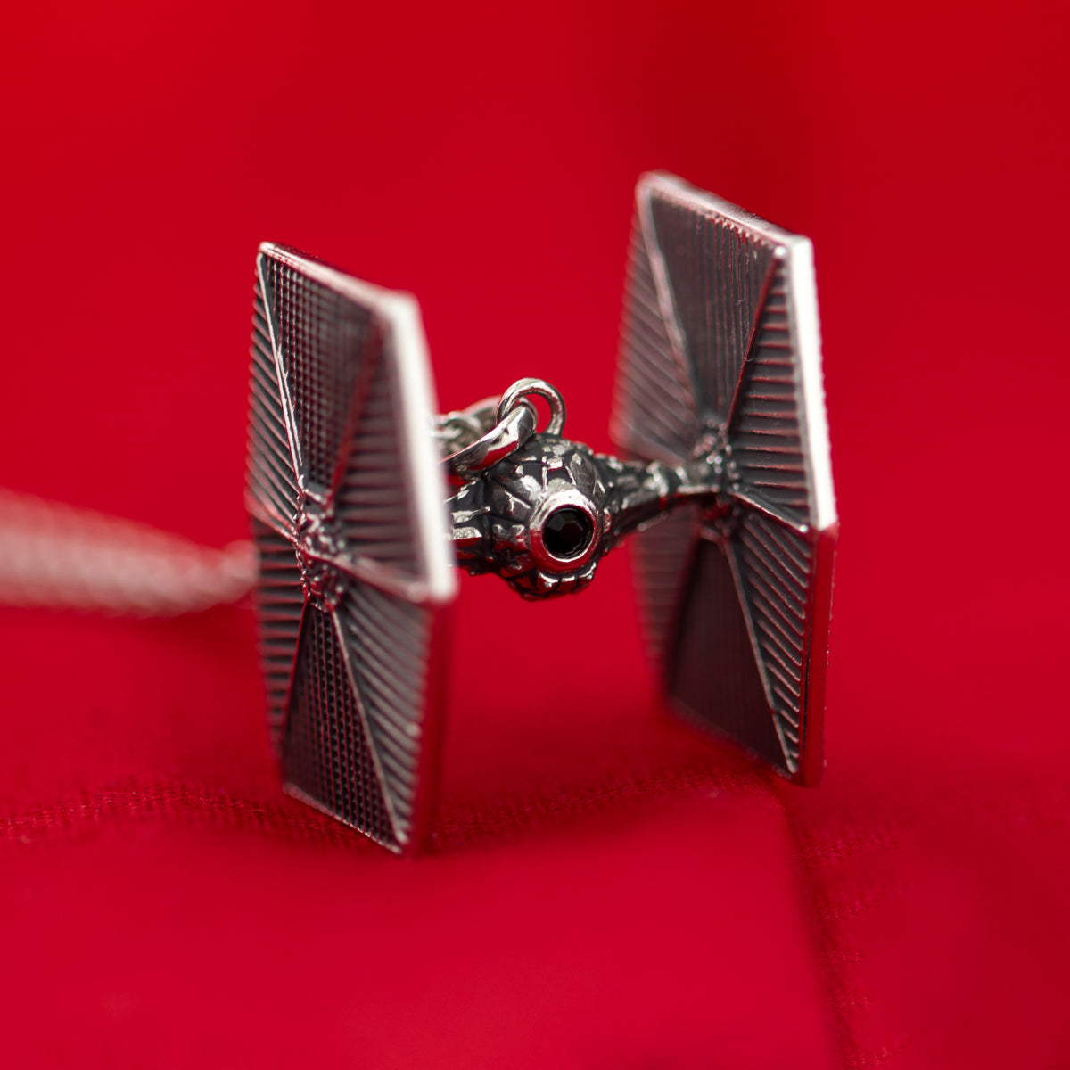 Side profile of the TIE Fighter pendant highlighting the three-dimensional sculpting and antiqued finish.