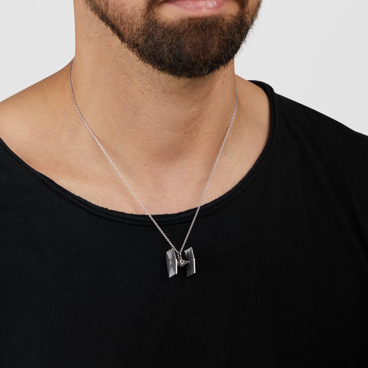 Front view of the handcrafted 3D TIE Fighter jewelry piece showing intricate silver detailing.